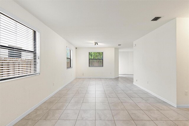 150 NE 23rd Ter, Homestead, FL 33033 - empty room featuring light tile patterned floors and baseboards