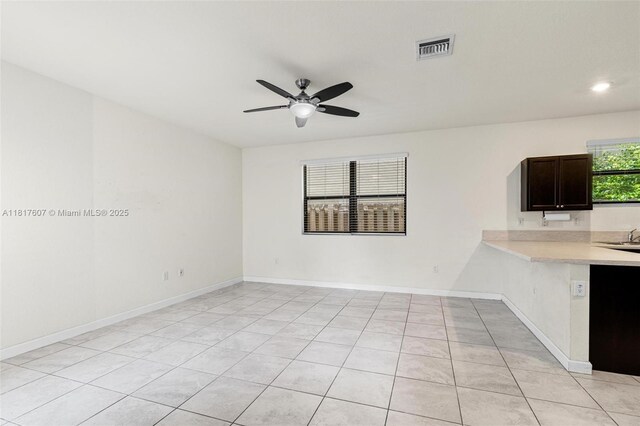 150 NE 23rd Ter, Homestead, FL 33033 - kitchen with light countertops, a ceiling fan, light tile patterned floors, baseboards, and recessed lighting