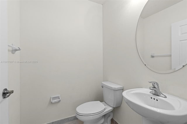150 NE 23rd Ter, Homestead, FL 33033 - bathroom with a sink, toilet, and baseboards