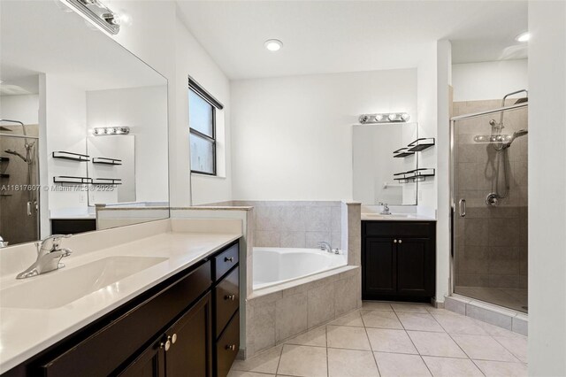 150 NE 23rd Ter, Homestead, FL 33033 - full bathroom featuring a shower stall, tile patterned floors, two vanities, a garden tub, and recessed lighting