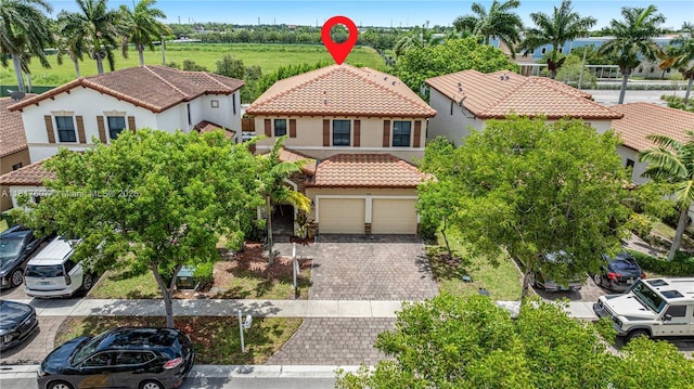 150 NE 23rd Ter, Homestead, FL 33033 - view of front of home featuring a tile roof, stucco siding, decorative driveway, and a residential view