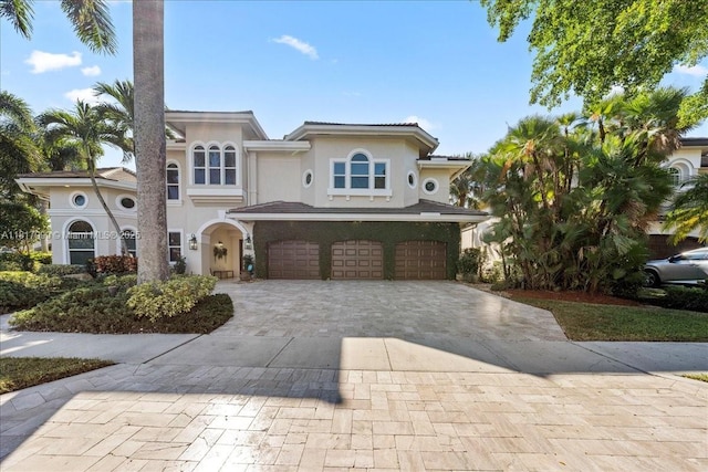 3212 NW 64th St, Boca Raton, FL 33496 - mediterranean / spanish house with a garage, stucco siding, and decorative driveway