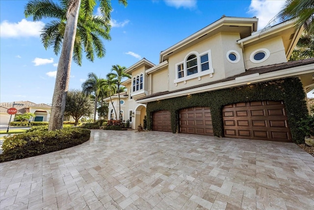 3212 NW 64th St, Boca Raton, FL 33496 - mediterranean / spanish home with stucco siding, an attached garage, and decorative driveway