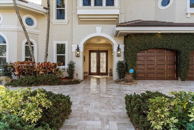 3212 NW 64th St, Boca Raton, FL 33496 - entrance to property featuring french doors, an attached garage, and stucco siding