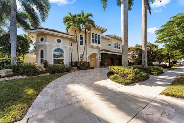 3212 NW 64th St, Boca Raton, FL 33496 - mediterranean / spanish house featuring stucco siding and curved driveway
