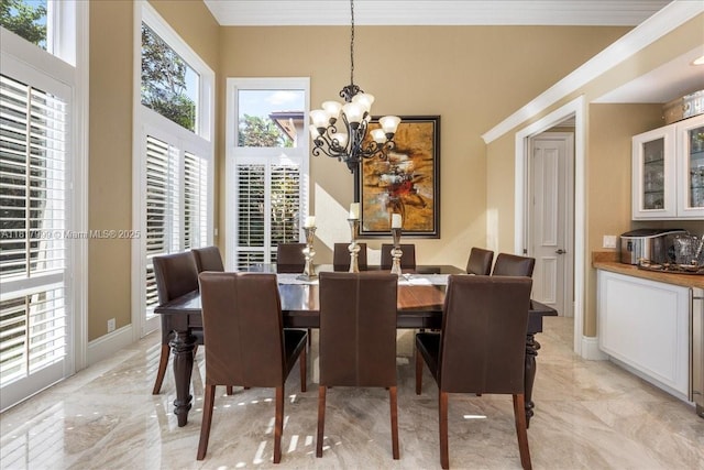 3212 NW 64th St, Boca Raton, FL 33496 - dining area featuring a chandelier, crown molding, light marble finish floors, and baseboards