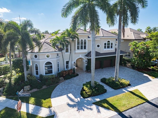 3212 NW 64th St, Boca Raton, FL 33496 - view of front of property with decorative driveway, a garage, stucco siding, and a tile roof