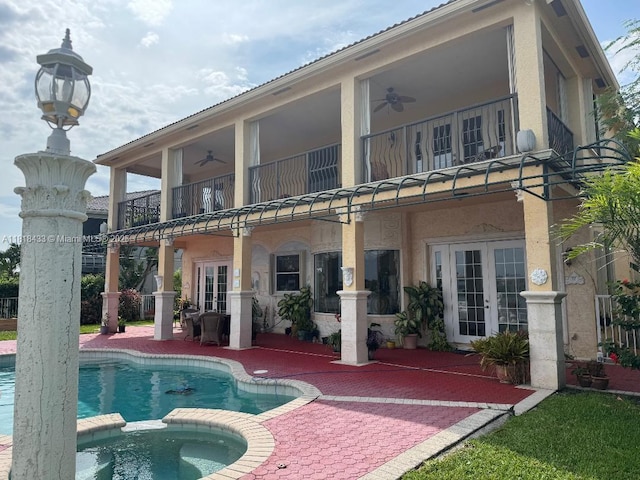 15341 SW 20th St, Miramar, FL 33027 - back of property featuring a balcony, french doors, a ceiling fan, a patio, and a pool with connected hot tub