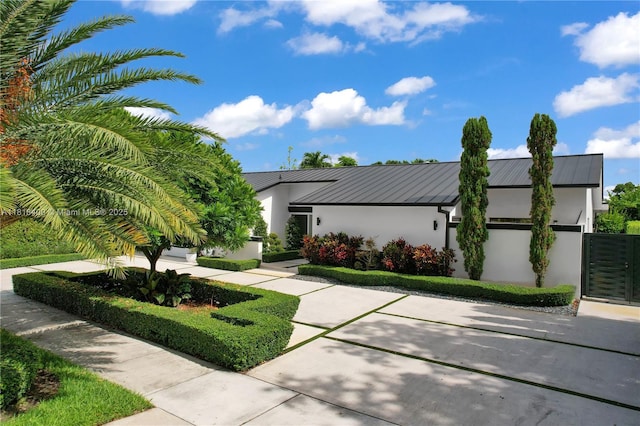 14051 SW 48th St, Miami, FL 33175 - view of front of property featuring a standing seam roof, stucco siding, and metal roof