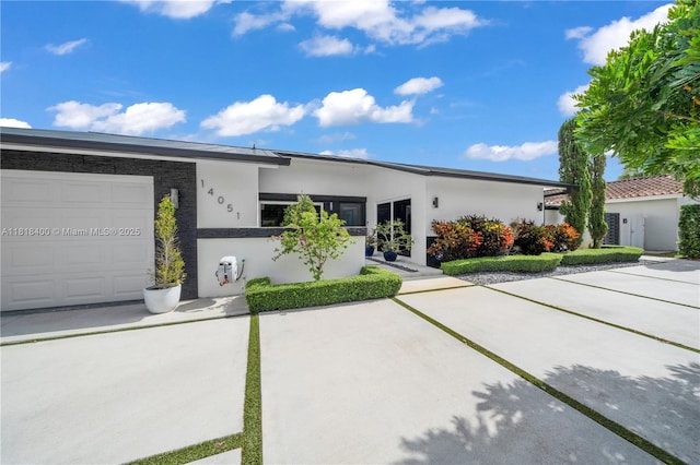 14051 SW 48th St, Miami, FL 33175 - view of front of property with stucco siding and a garage