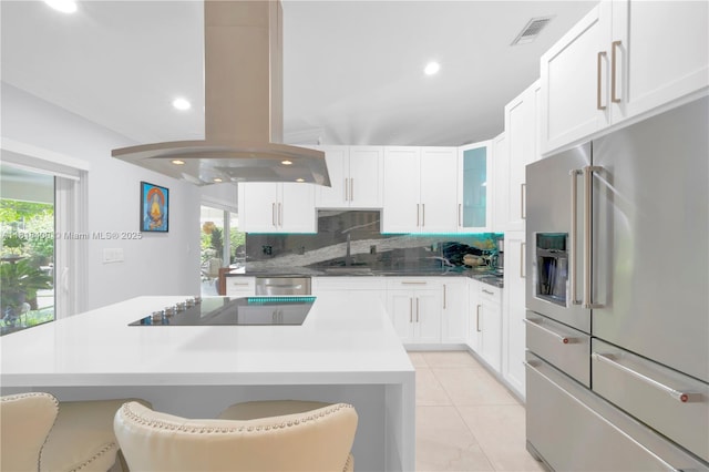14051 SW 48th St, Miami, FL 33175 - kitchen with stainless steel appliances, island range hood, a center island, recessed lighting, and white cabinets