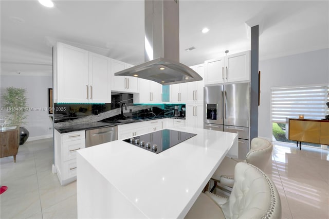 14051 SW 48th St, Miami, FL 33175 - kitchen with island range hood, appliances with stainless steel finishes, light tile patterned floors, backsplash, and white cabinets