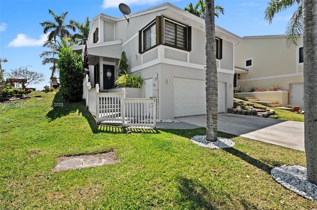 9916 SW 218th Ter, Cutler Bay, FL 33190 - view of front of home with stucco siding, an attached garage, driveway, and a front yard
