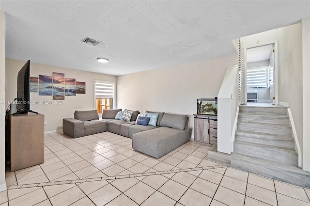 9916 SW 218th Ter, Cutler Bay, FL 33190 - living room featuring light tile patterned floors, a textured ceiling, and baseboards