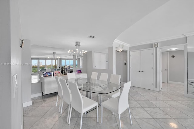 2100 S Ocean Ln Unit 703, Fort Lauderdale, FL 33316 - dining room featuring a chandelier, ornamental molding, and light marble finish flooring