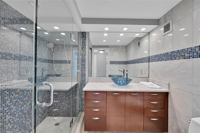 2100 S Ocean Ln Unit 703, Fort Lauderdale, FL 33316 - full bathroom with tile walls, vanity, a shower stall, and recessed lighting