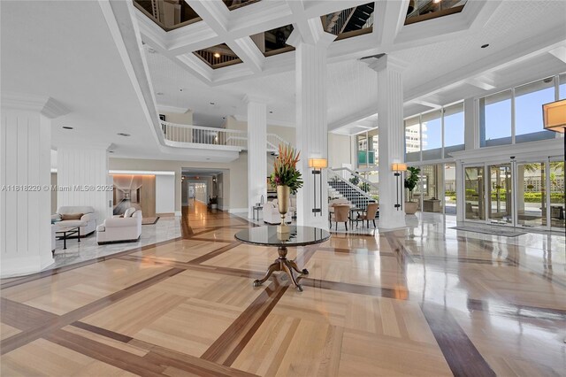 2100 S Ocean Ln Unit 703, Fort Lauderdale, FL 33316 - building lobby featuring a towering ceiling, coffered ceiling, beamed ceiling, and stairway