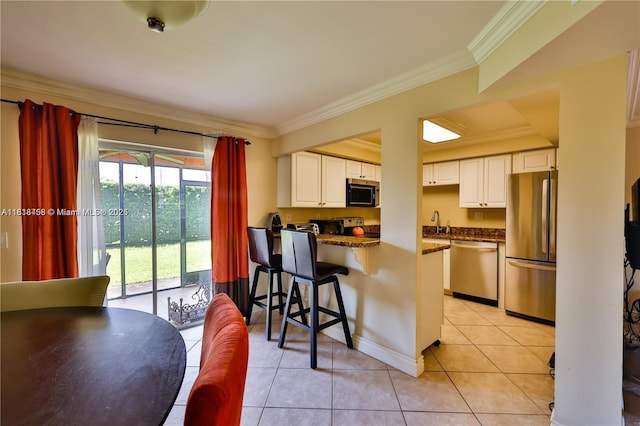 1325 Partridge Close, Pompano Beach, FL 33064 - kitchen with stainless steel appliances, light tile patterned flooring, a peninsula, ornamental molding, and white cabinetry