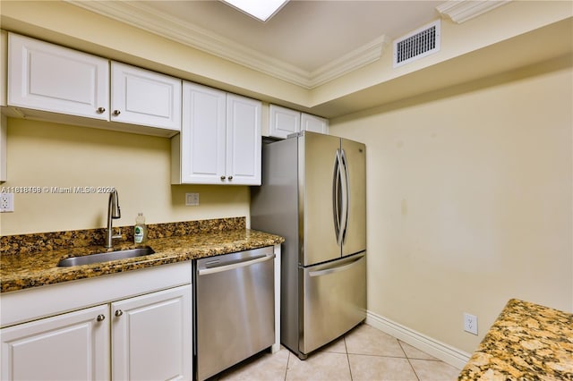1325 Partridge Close, Pompano Beach, FL 33064 - kitchen with stainless steel appliances, crown molding, white cabinets, light tile patterned flooring, and dark stone countertops
