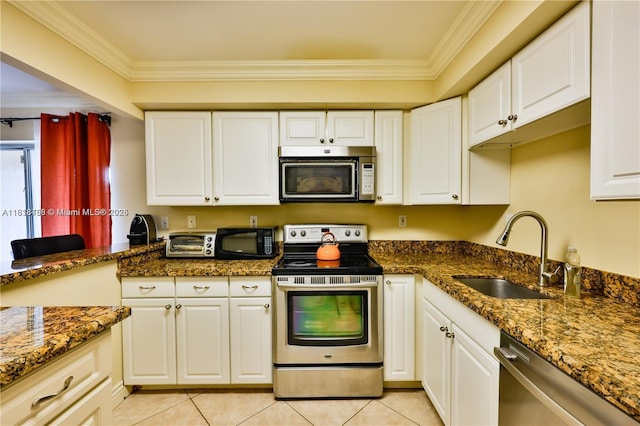 1325 Partridge Close, Pompano Beach, FL 33064 - kitchen featuring appliances with stainless steel finishes, crown molding, light tile patterned floors, and white cabinets