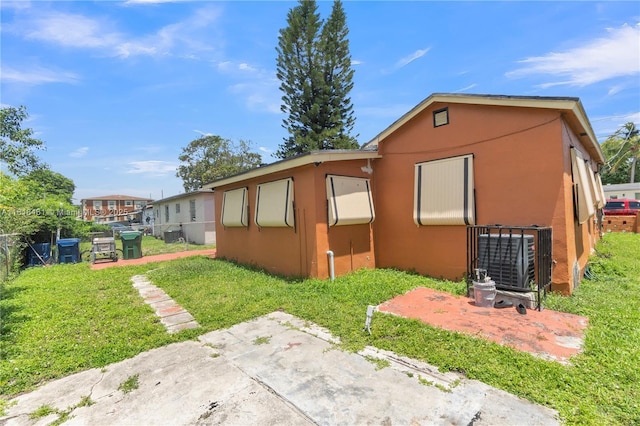1478 NW 74th St, Miami, FL 33147 - view of side of home featuring stucco siding
