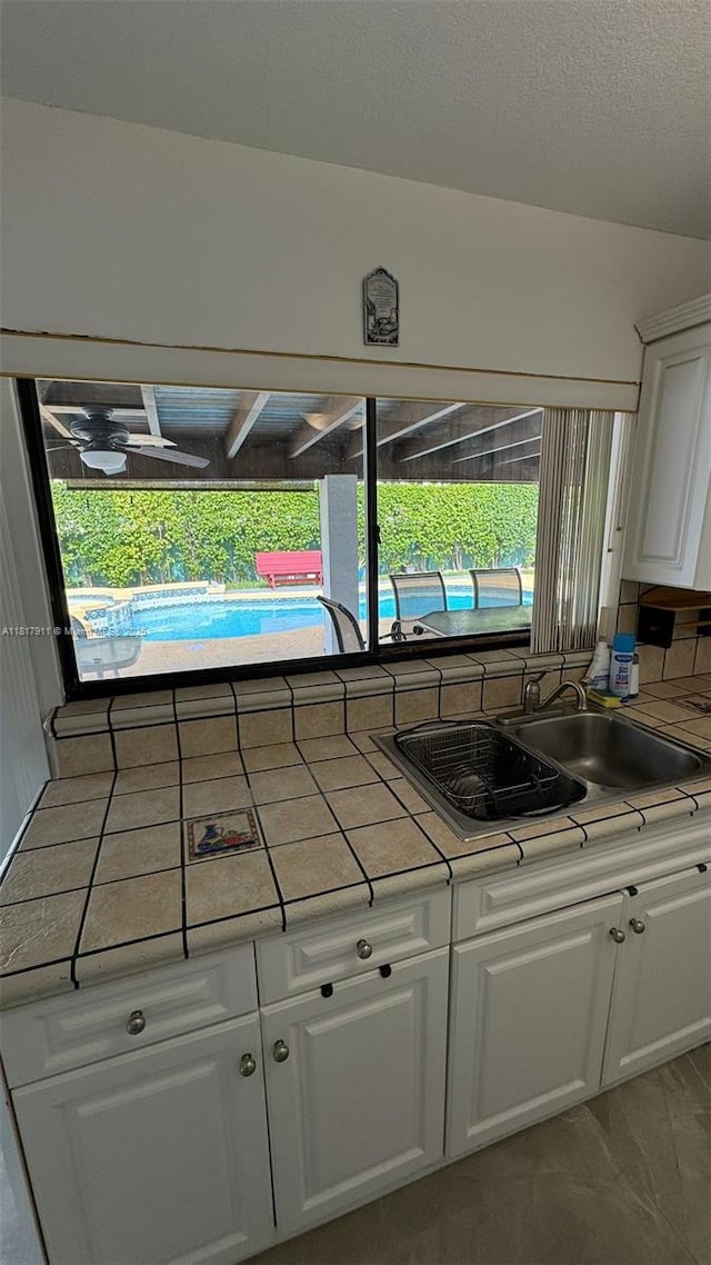 7115 SW 147th Ct, Miami, FL 33193 - detailed view of white cabinets, tasteful backsplash, and tile countertops