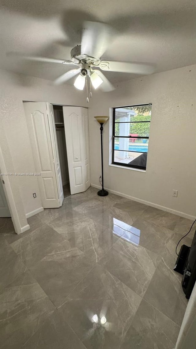 7115 SW 147th Ct, Miami, FL 33193 - unfurnished bedroom featuring marble finish flooring, a closet, and a ceiling fan