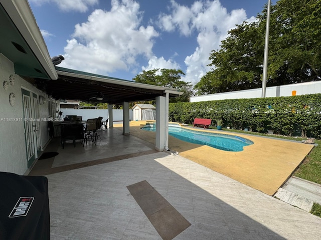 7115 SW 147th Ct, Miami, FL 33193 - view of pool with a storage unit, a patio area, a fenced backyard, and outdoor dining area