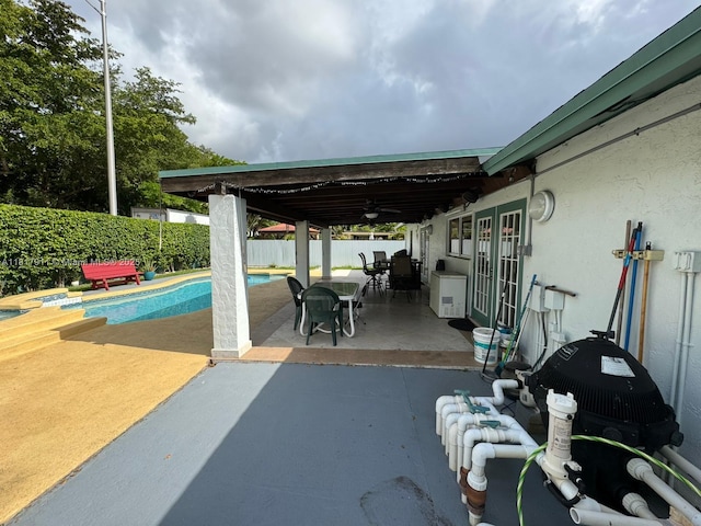 7115 SW 147th Ct, Miami, FL 33193 - fenced backyard with a patio area, outdoor dining space, and a ceiling fan