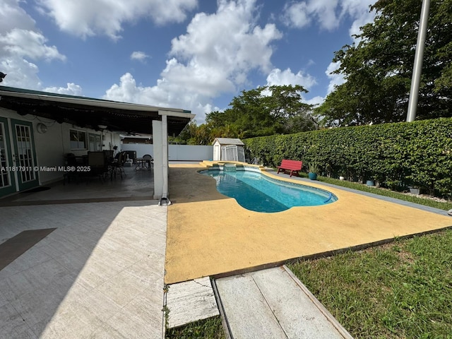 7115 SW 147th Ct, Miami, FL 33193 - view of pool with a patio, a storage unit, a fenced backyard, ceiling fan, and outdoor dining area