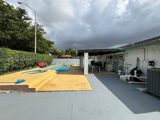 7115 SW 147th Ct, Miami, FL 33193 - view of swimming pool with a patio area, an in-ground hot tub, and a fenced backyard