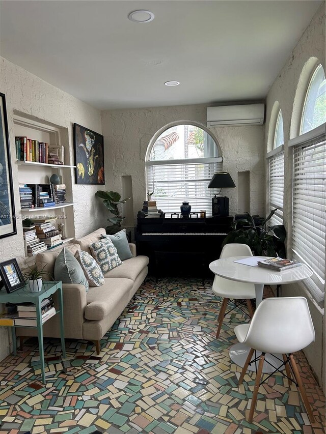2320 SW 16th Ter, Miami, FL 33145 - living area featuring a wall mounted air conditioner and a textured wall