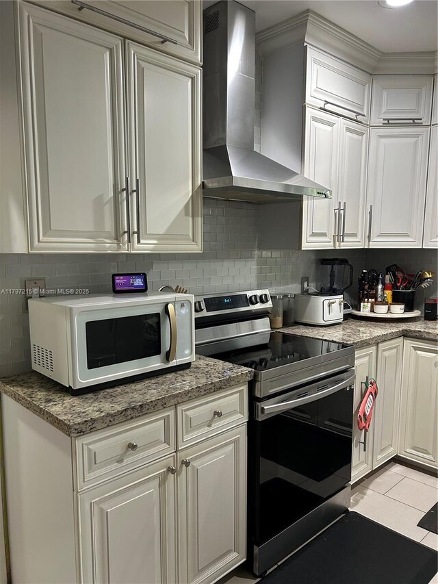 2320 SW 16th Ter, Miami, FL 33145 - kitchen featuring wall chimney exhaust hood, electric stove, white microwave, and white cabinets