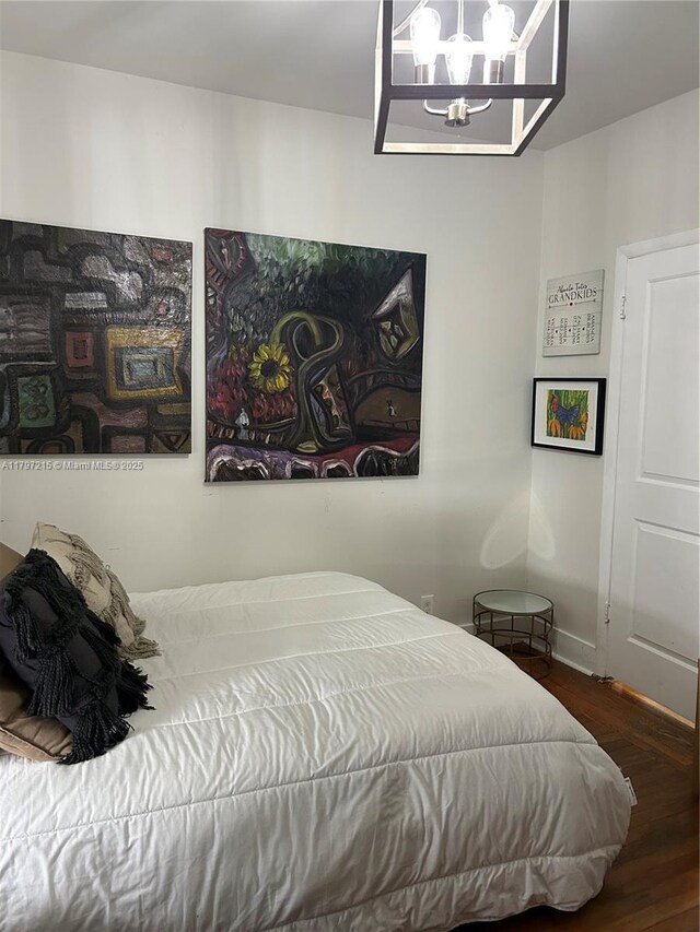 2320 SW 16th Ter, Miami, FL 33145 - bedroom featuring wood finished floors and a chandelier