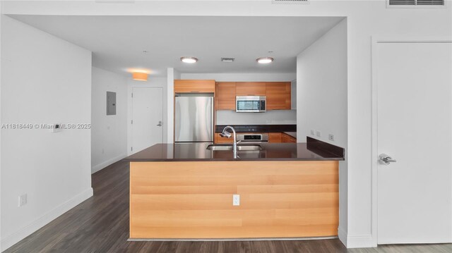 3301 NE 1st Ave Unit H1612, Miami, FL 33137 - kitchen with stainless steel appliances, a sink, dark countertops, electric panel, and a peninsula