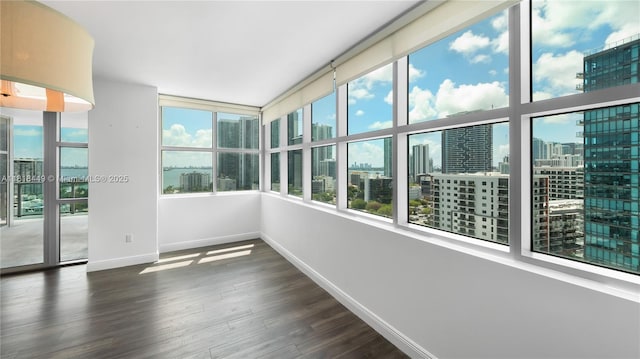 3301 NE 1st Ave Unit H1612, Miami, FL 33137 - unfurnished sunroom featuring a city view, baseboards, and wood finished floors