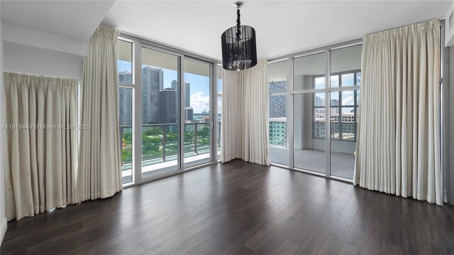 3301 NE 1st Ave Unit H1612, Miami, FL 33137 - unfurnished dining area with floor to ceiling windows, a chandelier, dark wood finished floors, and a city view