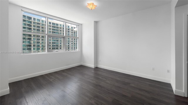 3301 NE 1st Ave Unit H1612, Miami, FL 33137 - empty room with dark wood finished floors and baseboards