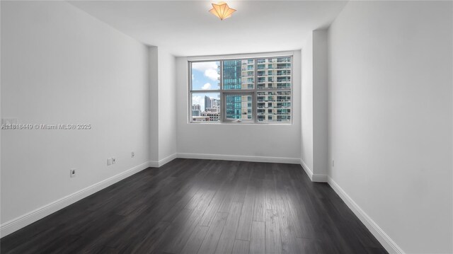3301 NE 1st Ave Unit H1612, Miami, FL 33137 - empty room featuring dark wood finished floors and baseboards