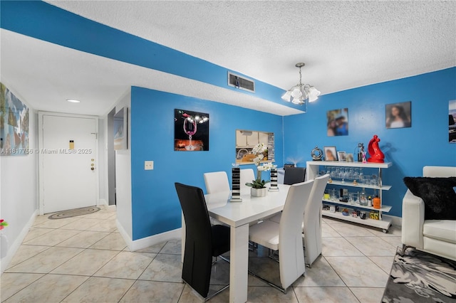 8415 SW 107th Ave Unit 323W, Miami, FL 33173 - dining area featuring a chandelier, a textured ceiling, and light tile patterned flooring
