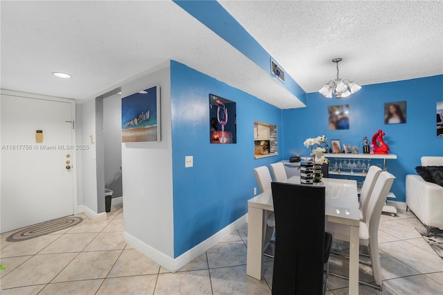 8415 SW 107th Ave Unit 323W, Miami, FL 33173 - tiled dining space with a chandelier, a textured ceiling, recessed lighting, and baseboards