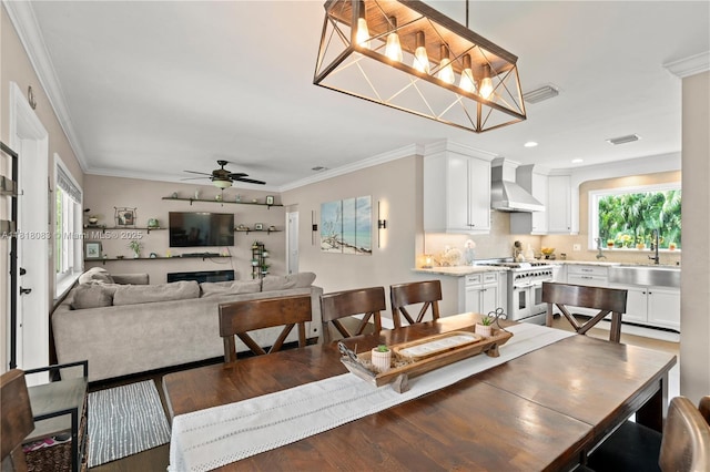 4240 SW 9th St, Plantation, FL 33317 - dining space with ornamental molding, a ceiling fan, wood finished floors, and recessed lighting