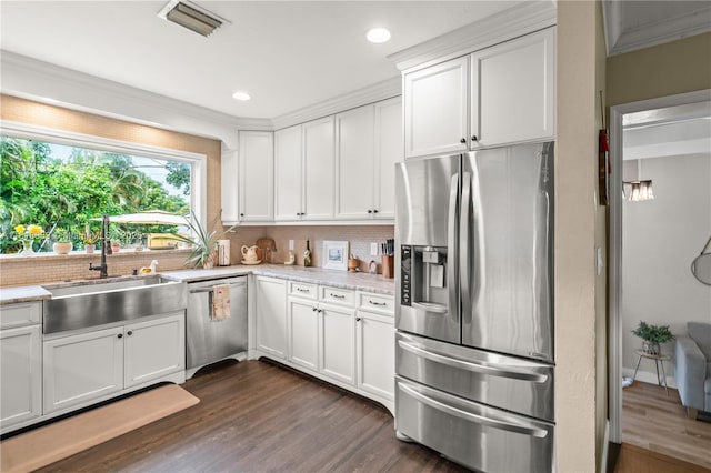 4240 SW 9th St, Plantation, FL 33317 - kitchen with appliances with stainless steel finishes, backsplash, dark wood-style floors, white cabinetry, and recessed lighting
