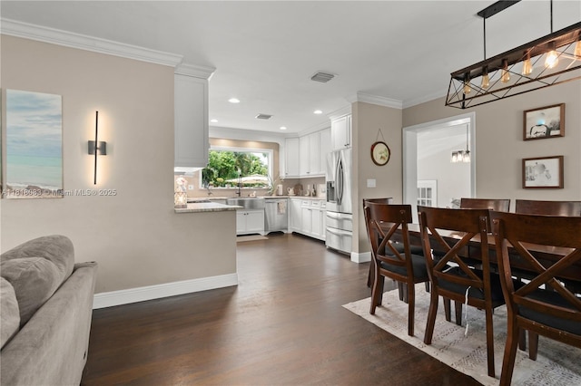 4240 SW 9th St, Plantation, FL 33317 - dining area with a chandelier, dark wood-style floors, crown molding, and recessed lighting
