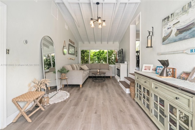 4240 SW 9th St, Plantation, FL 33317 - living area with a chandelier, light wood finished floors, and vaulted ceiling