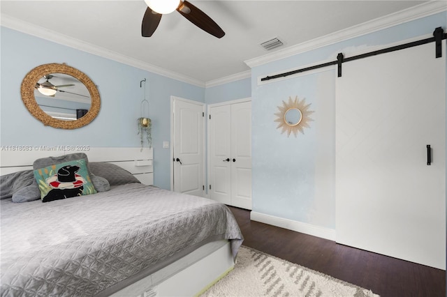 4240 SW 9th St, Plantation, FL 33317 - bedroom with a barn door, wood finished floors, ornamental molding, a closet, and ceiling fan