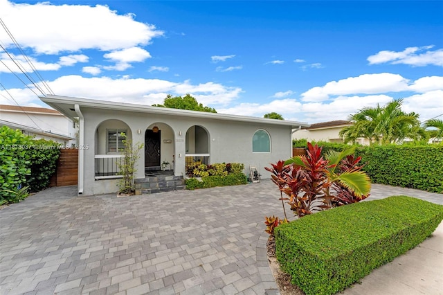 3075 SW 19th St, Miami, FL 33145 - view of front of property with stucco siding and a porch