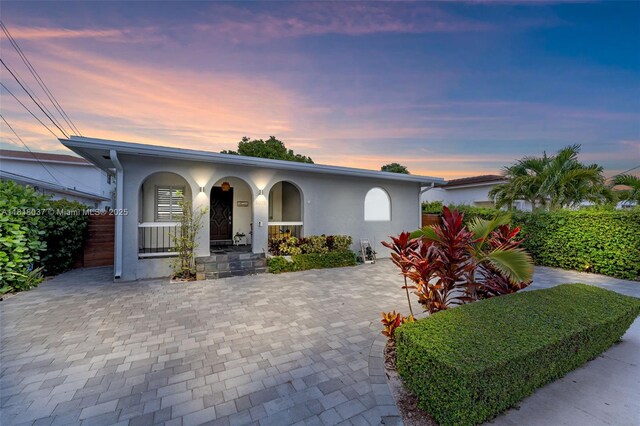 3075 SW 19th St, Miami, FL 33145 - ranch-style house featuring stucco siding and a porch