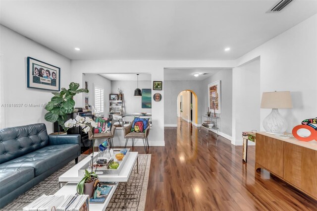 3075 SW 19th St, Miami, FL 33145 - living room with arched walkways, wood finished floors, and recessed lighting