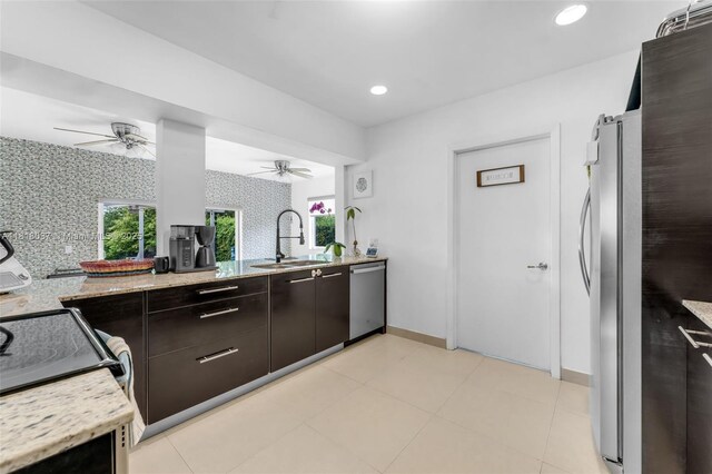 3075 SW 19th St, Miami, FL 33145 - kitchen featuring appliances with stainless steel finishes, ceiling fan, healthy amount of natural light, light stone countertops, and recessed lighting
